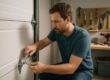 Homeowner safely tightening garage door hinge bolt - DIY garage door maintenance Chesapeake VA
