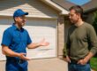 Garage door technician advising homeowner on repair vs replacement decision